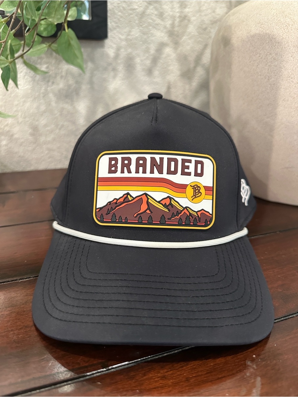 Branded Black Trucker Hat with Retro Mountain Patch